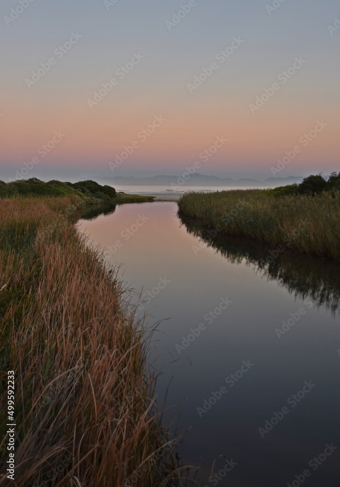 Landscape with a beautiful sunrise over the Lourensrivier in Strand