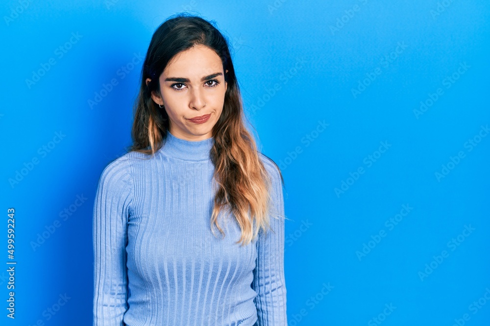 Obraz premium Young hispanic girl wearing casual clothes depressed and worry for distress, crying angry and afraid. sad expression.