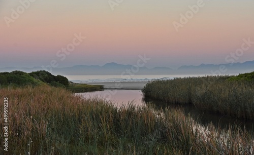 Landscape with a beautiful sunrise over the Lourensrivier in Strand © lehmannw