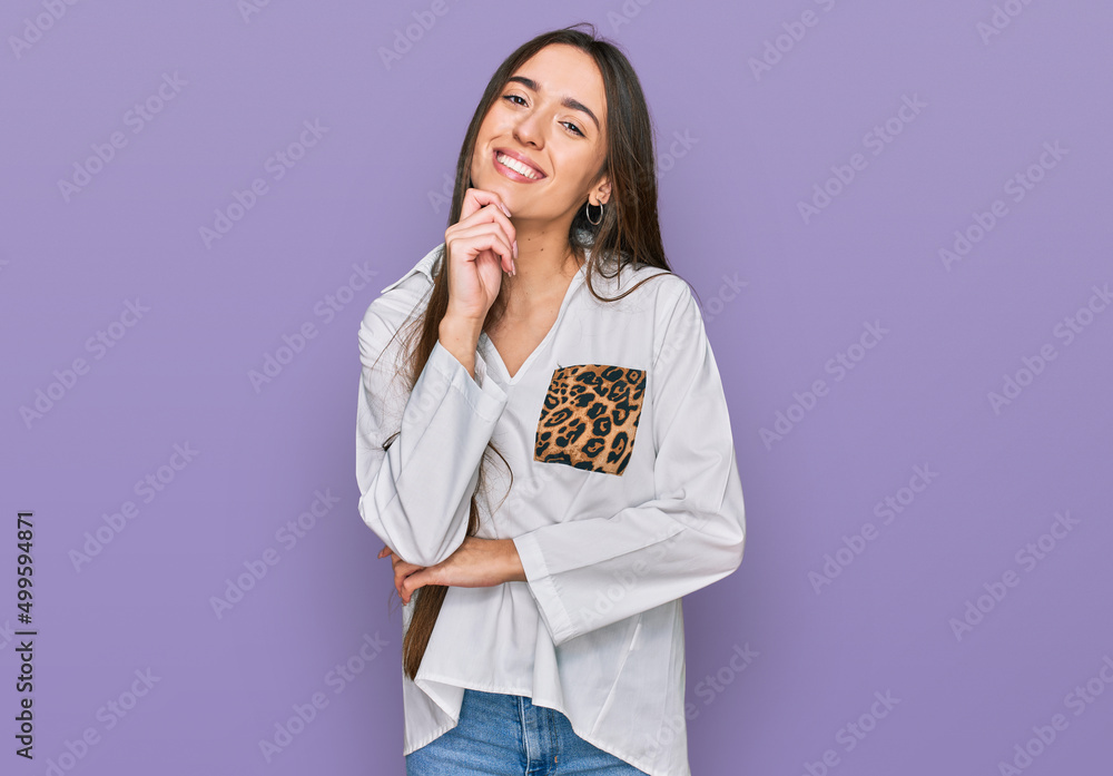 Young hispanic girl wearing casual clothes looking confident at the camera with smile with crossed arms and hand raised on chin. thinking positive. Young hispanic girl wearing casual clothes looking confident at the camera with smile with crossed arms and hand raised on chin. thinking positive.