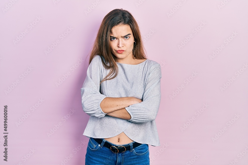 Young caucasian girl wearing casual clothes skeptic and nervous, disapproving expression on face with crossed arms. negative person. Young caucasian girl wearing casual clothes skeptic and nervous, disapproving expression on face with crossed arms. negative person.