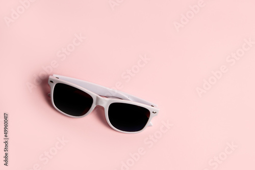 White sunglasses on pink background