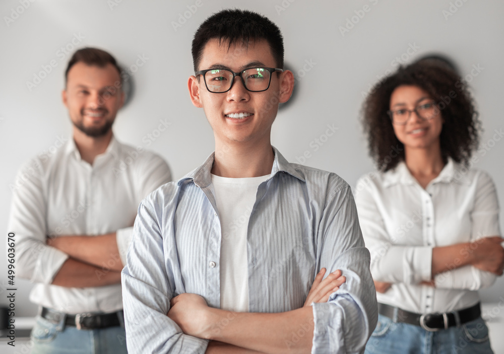 Cheerful multiethnic colleagues standing in office Cheerful multiethnic colleagues standing in office