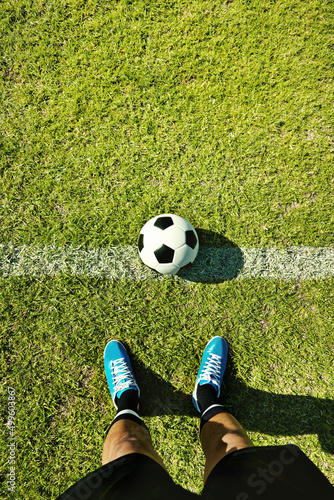 Ready for kick-off. POV shot of a soccer player standing on the field. © peopleimages.com