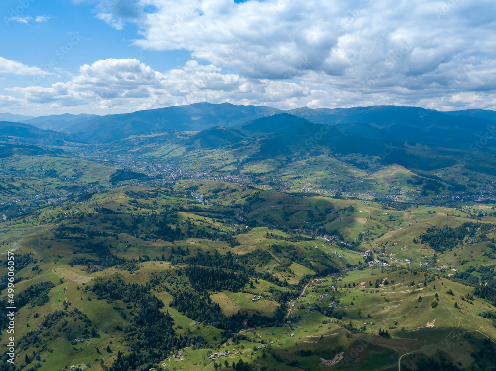 Obraz premium Green mountains of Ukrainian Carpathians in summer. Coniferous trees on the slopes. Aerial drone view.
