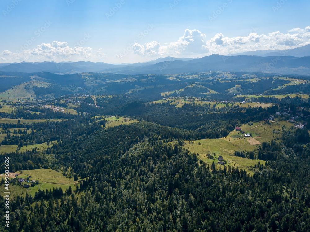 Fototapeta premium Green mountains of Ukrainian Carpathians in summer. Sunny day. Aerial drone view.