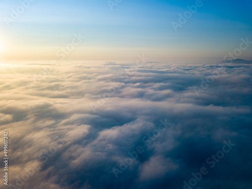 High flight above the clouds. Aerial drone view.