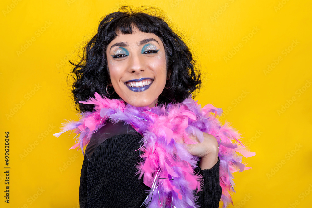 The young woman is wearing a scarf with pink and purple feathers. Beautiful woman has fun at the party. Party concept. The young woman is wearing a scarf with pink and purple feathers. Beautiful woman has fun at the party. Party concept.