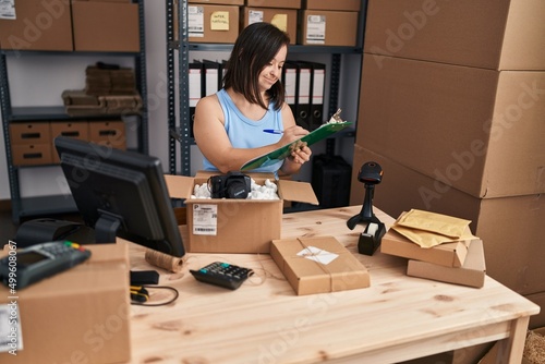 Down syndrome woman ecommerce business worker working at office