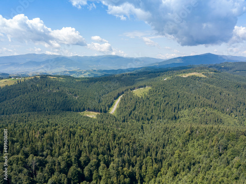 Green mountains of Ukrainian Carpathians in summer. Sunny day. Aerial drone view.