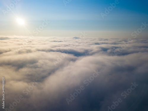 High flight above the clouds. Aerial drone view. © Sergey