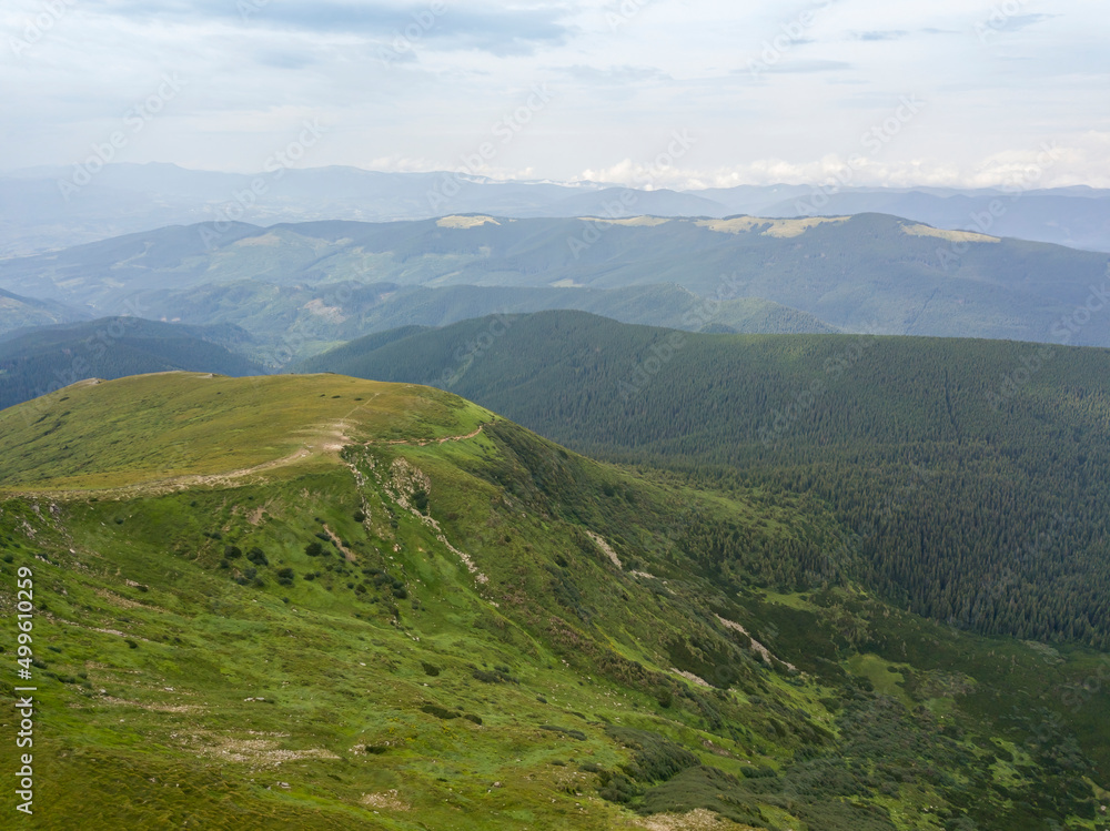 High mountains of the Ukrainian Carpathians in cloudy weather. Aerial drone view.