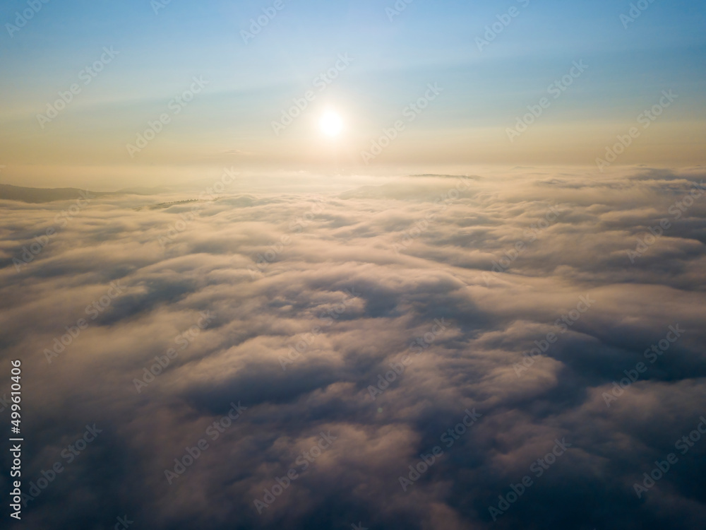 Obraz premium High flight above the clouds. Aerial drone view.