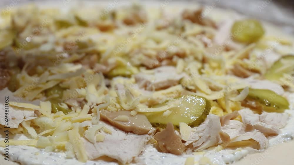 chef pouring cheese on pizza close-up. italian food preparation in a restaurant chef pouring cheese on pizza close-up. italian food preparation in a restaurant