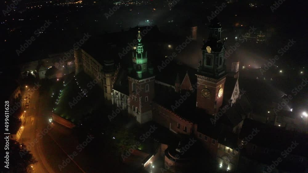 Aerial view of Crakow Royal Wawel Castle at night in the autumn fog.Crakow, Poland. Aerial view of Crakow Royal Wawel Castle at night in the autumn fog.Crakow, Poland.