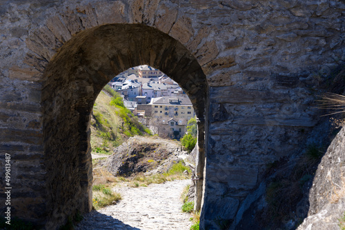 Beautiful view through stone arch of ruins of medieval Tourbillon Castle on a hill at City of Sion on a sunny spring day. Photo taken April 4th, 2022, Sion, Switzerland.