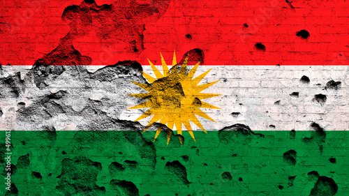 Flag of Kurdistan painted on damaged brick wall. Military conflict, war concept photo