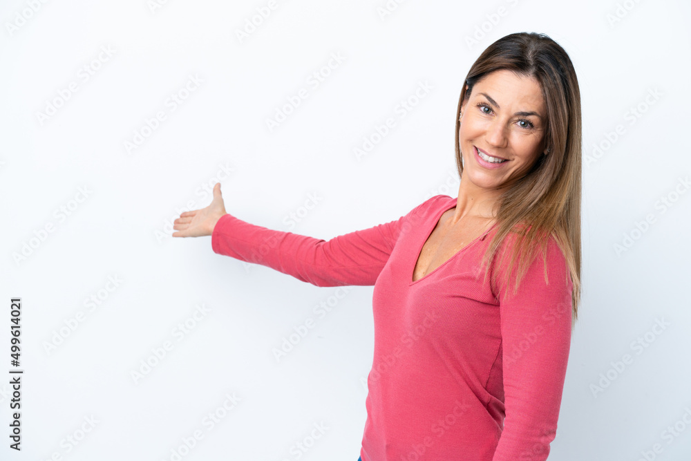 Middle age caucasian woman isolated on white background extending hands to the side for inviting to come Middle age caucasian woman isolated on white background extending hands to the side for inviting to come