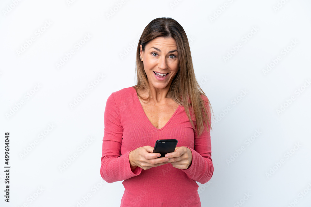Middle age caucasian woman isolated on white background surprised and sending a message Middle age caucasian woman isolated on white background surprised and sending a message