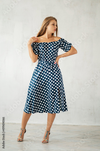 Wallpaper Mural Girl in polka-dot dress at grey wall. Summer women's wardrobe Torontodigital.ca