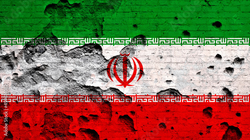 Flag of Iran painted on damaged brick wall. Military conflict, war concept photo