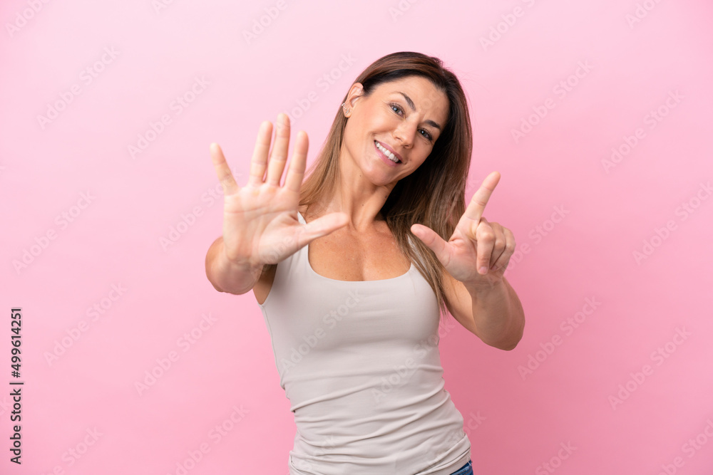 Middle age caucasian woman isolated on pink background counting seven with fingers Middle age caucasian woman isolated on pink background counting seven with fingers