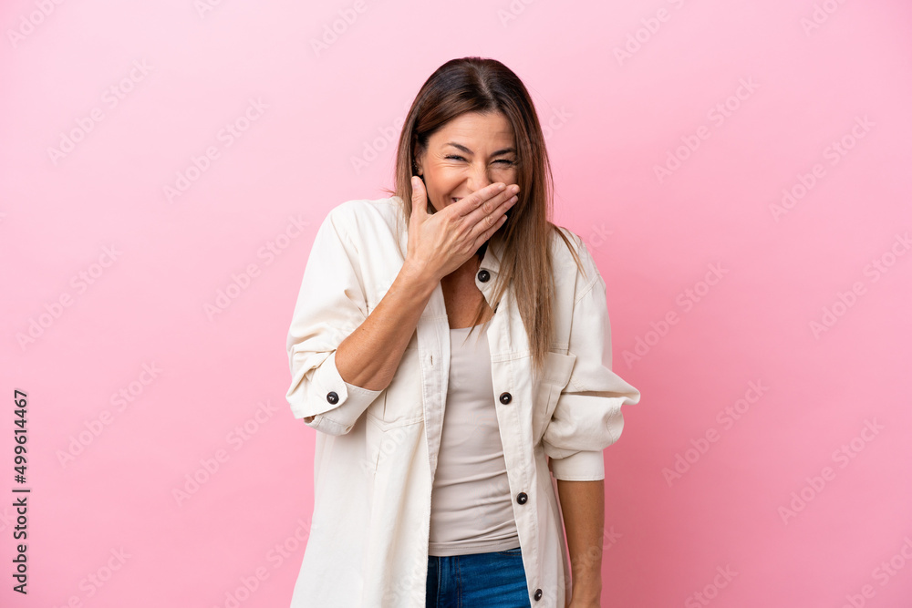 Middle age caucasian woman isolated on pink background happy and smiling covering mouth with hand Middle age caucasian woman isolated on pink background happy and smiling covering mouth with hand