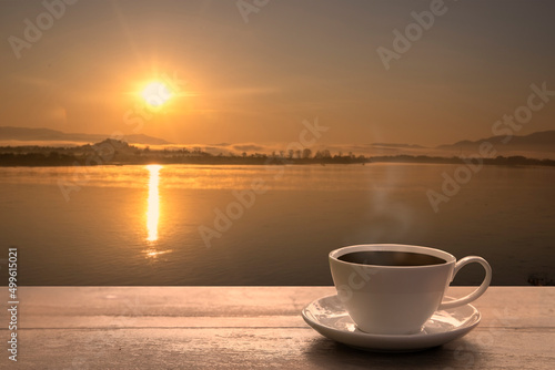 Coffee cup on wooden table in the morning, Coffee in the nature view. © aumnat