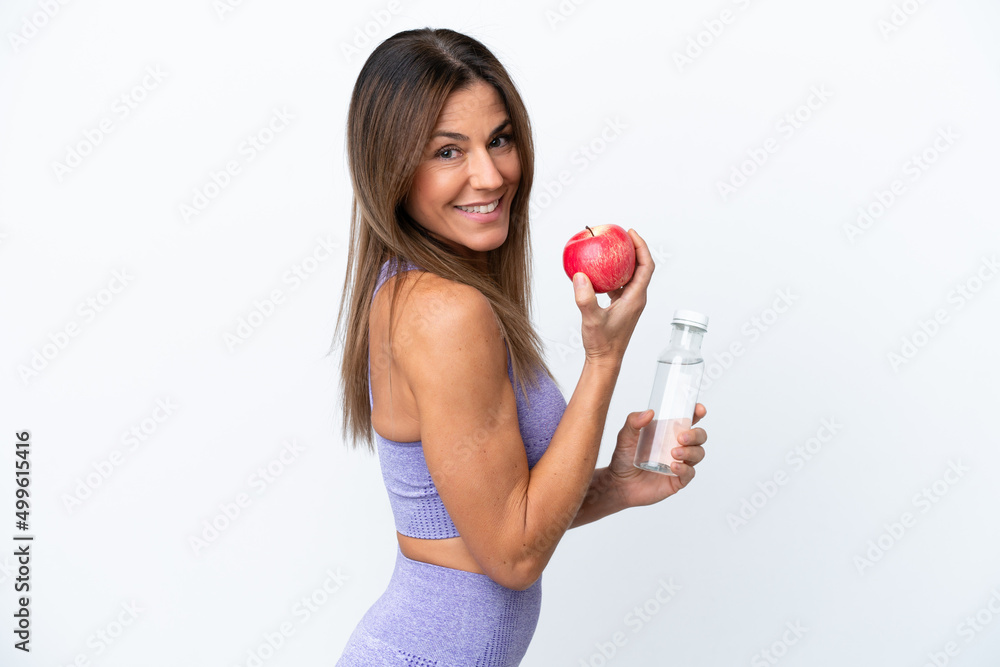Middle age caucasian woman isolated on white background with an apple and with a bottle of water Middle age caucasian woman isolated on white background with an apple and with a bottle of water