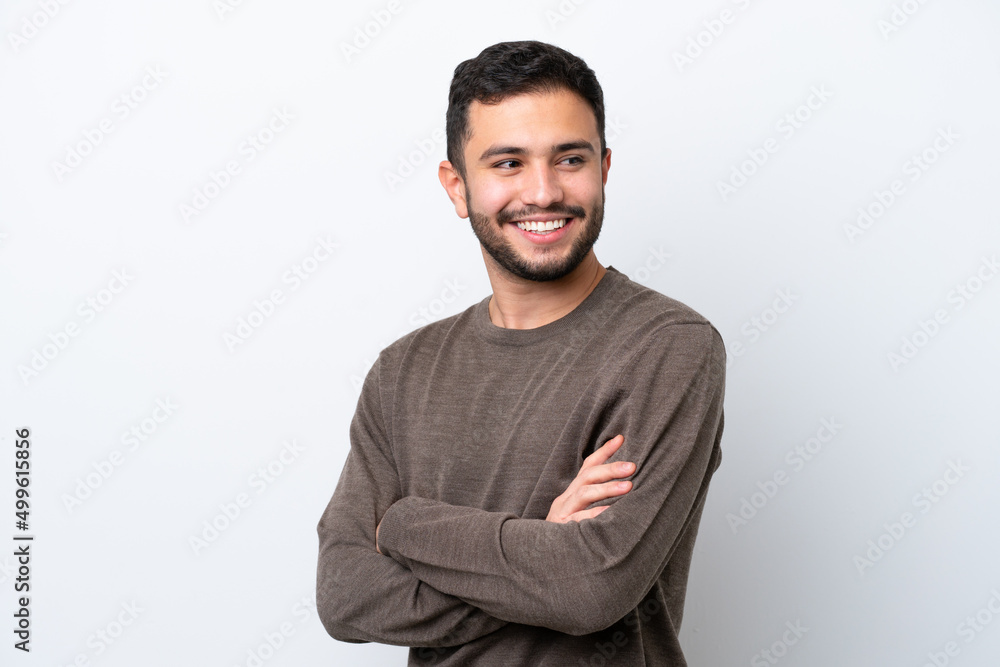 Young Brazilian man isolated on white background with arms crossed and happy Young Brazilian man isolated on white background with arms crossed and happy