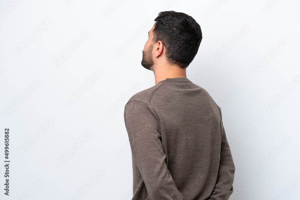 Young Brazilian man isolated on white background in back position and looking back Young Brazilian man isolated on white background in back position and looking back