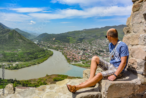 A man on the background of a view of the Mtkvari River flowing into the Aragvi. Mtskheta Georgia 2019