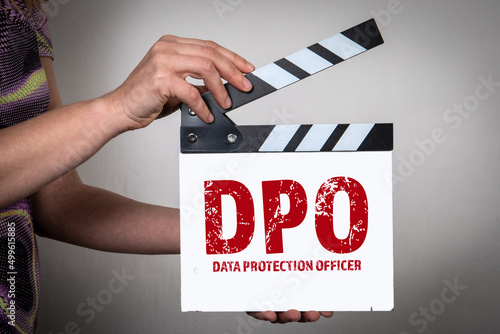 DPO Data Protection Officer Concept. Female hands holding movie clapper photo