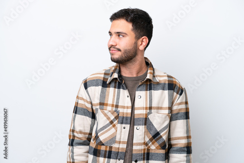 Young Brazilian man isolated on white background looking to the side