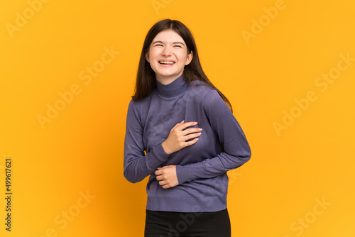 Young Ukrainian girl isolated on yellow background smiling a lot © luismolinero