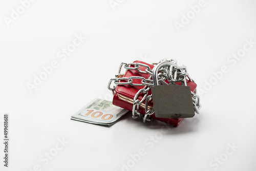 Financial topic. Red ladies wallet locked with a chain and padlock on the white background