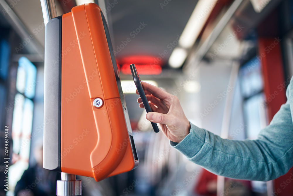 Man buying ticket via digital wallet. Contactless paying for public  transportation with mobile phone.. Stock Photo | Adobe Stock