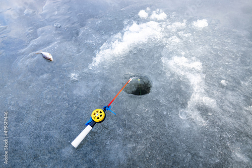 Ice fishing rod with the lure by the hole