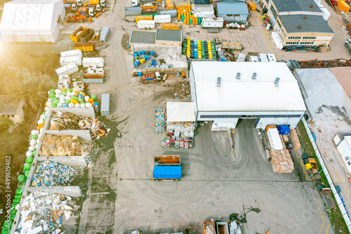 Top view of a landfill with various waste. Many dumpsters and garbage trucks sorting and recycling garbage in the industrial areas of the city © Vladyslav