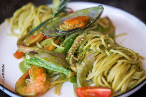 A delicious and delicious western food  seafood pasta with avocado green sauce