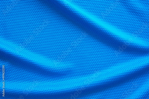 Blue football jersey clothing fabric texture sports wear background, close up top view