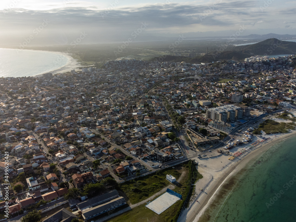 Fototapeta premium Charming paradise beach with fishing and tourism boats in a beautiful village, Praia dos Anjos, Arraial do Cabo, Rio de Janeiro