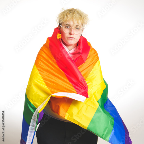 Woman wrapped in rainbow flag on a white background