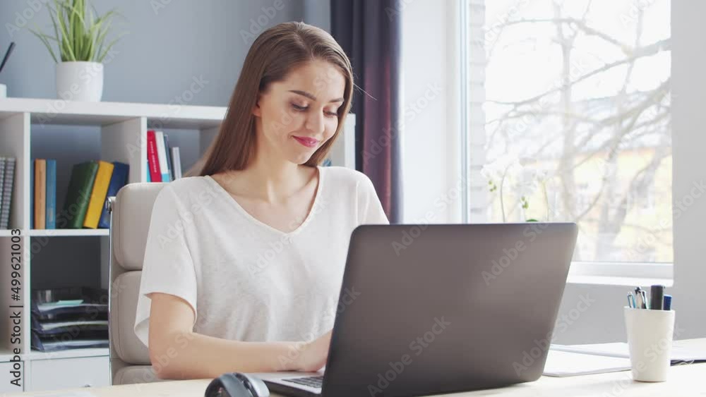 Young Woman Works at Home Office Using Computer. Workplace of Female Entrepreneur, Freelancer or Student. Remote Work and Education Concept. Young Woman Works at Home Office Using Computer. Workplace of Female Entrepreneur, Freelancer or Student. Remote Work and Education Concept.
