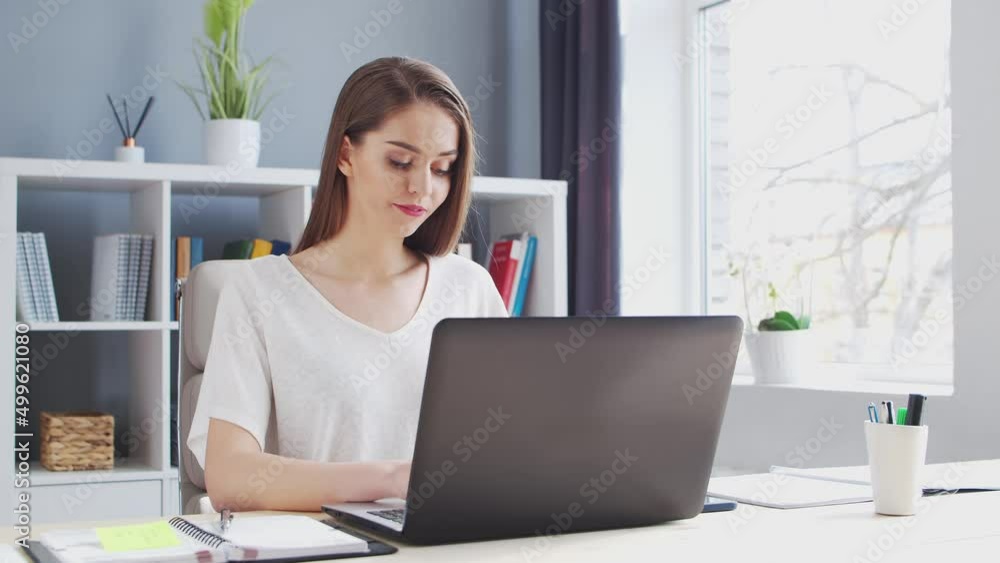 Young Woman Works at Home Office Using Computer. Workplace of Female Entrepreneur, Freelancer or Student. Remote Work and Education Concept. Young Woman Works at Home Office Using Computer. Workplace of Female Entrepreneur, Freelancer or Student. Remote Work and Education Concept.