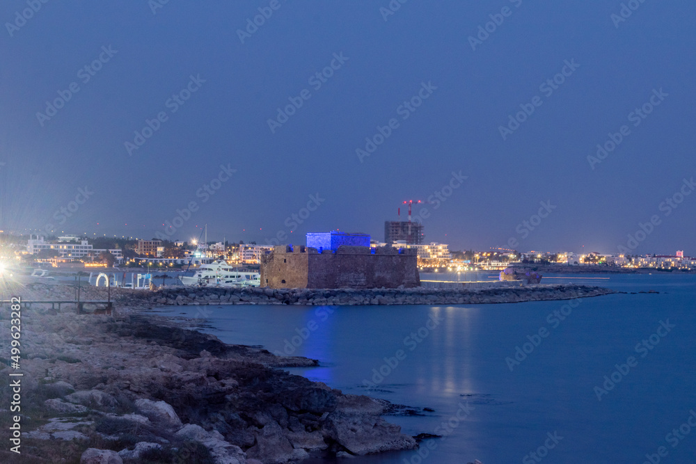 Evening view with Paphos Castle with reflection on the water. Dusk in Paphos, Cyprus.