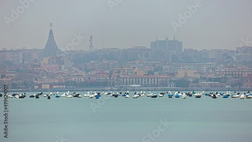 Static view of beautiful cityscape along the Arenella Beach (Spiaggia di Arenella) in Syracuse City, Sicily, Italy at daytime in timelapse. photo