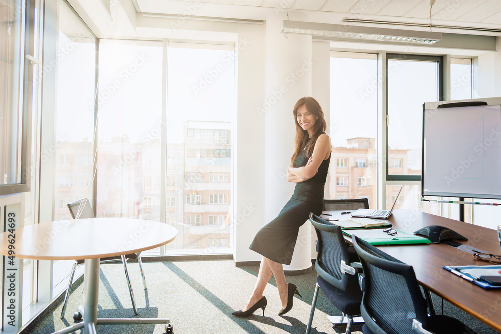 Confident businesswoman standing at the office Confident businesswoman standing at the office