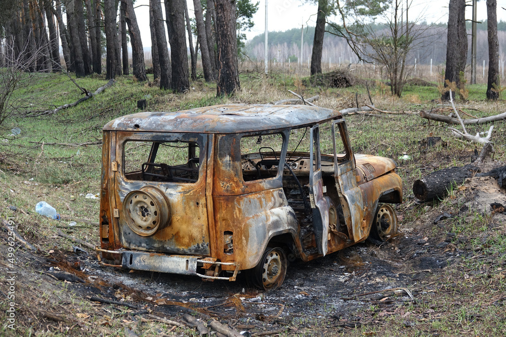 Military jeep. Burnt VAZ. Russia invaded Ukraine.