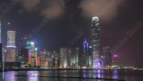 Wallpaper Mural Hong Kong city skyline at night over Victoria Harbor with cloudy sky and urban skyscrapers timelapse hyperlapse. Torontodigital.ca